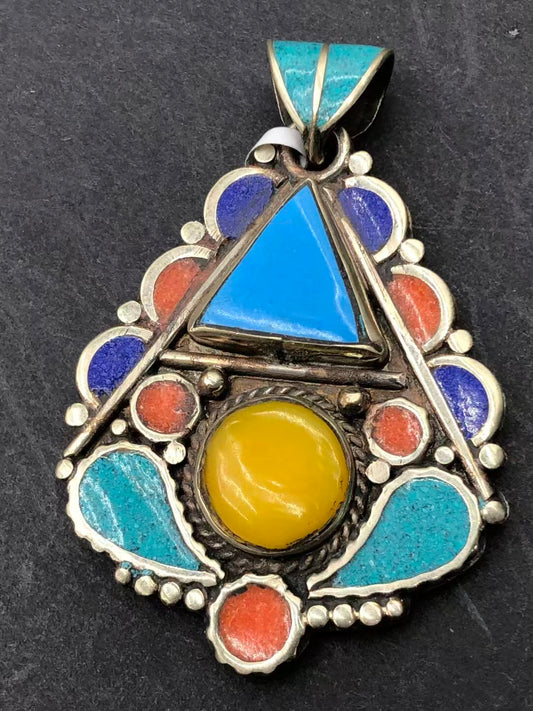 Handcrafted beeswax inlay pendant featuring Tibetan Buddhist designs. Symbolizes protection, healing, and spiritual growth with intricate craftsmanship.