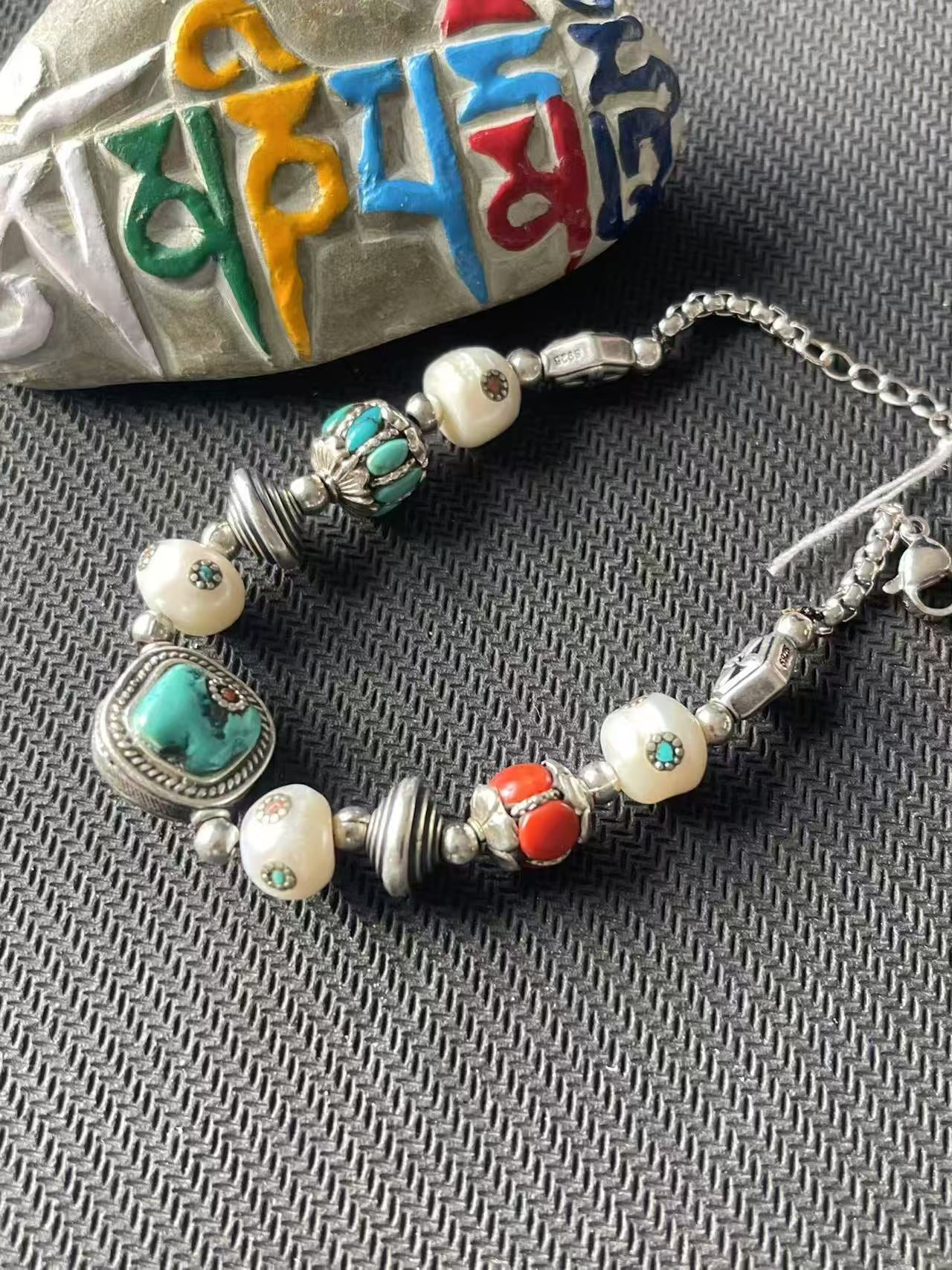 Vibrant and colorful multi-treasure bracelet, handcrafted with Tibetan Buddhist artistry, symbolizing spiritual energy and vitality, a unique accessory for daily wear.