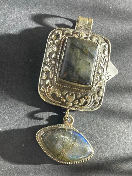 Handcrafted Labradorite pendant inspired by Tibetan Buddhist jewelry art. Symbolizing spiritual clarity and protection, a unique piece of craftsmanship.