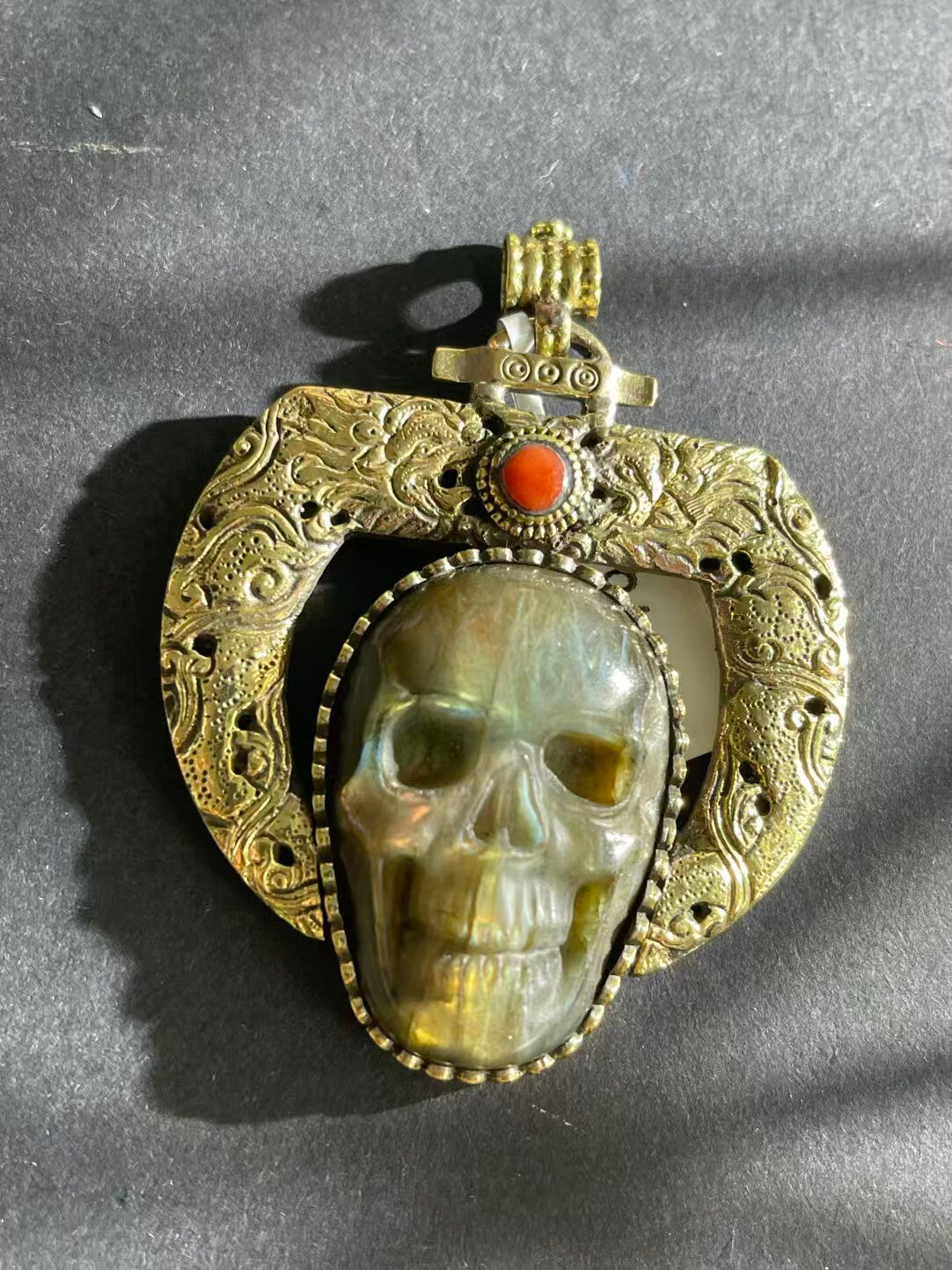 Handcrafted Labradorite pendant inspired by Tibetan Buddhist art. Symbolizes spiritual growth, transformation, and protection, a meaningful addition to any collection.