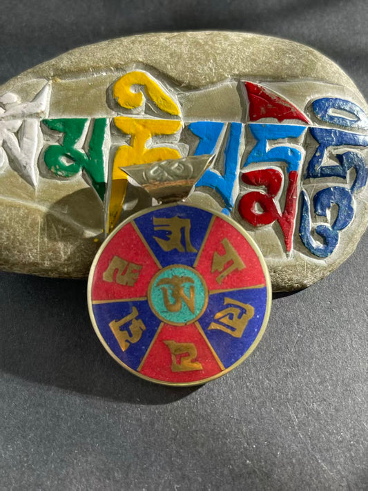 Handcrafted patch pendant with Tibetan Buddhist influences, showcasing intricate design and spiritual significance. A unique piece symbolizing protection and balance.