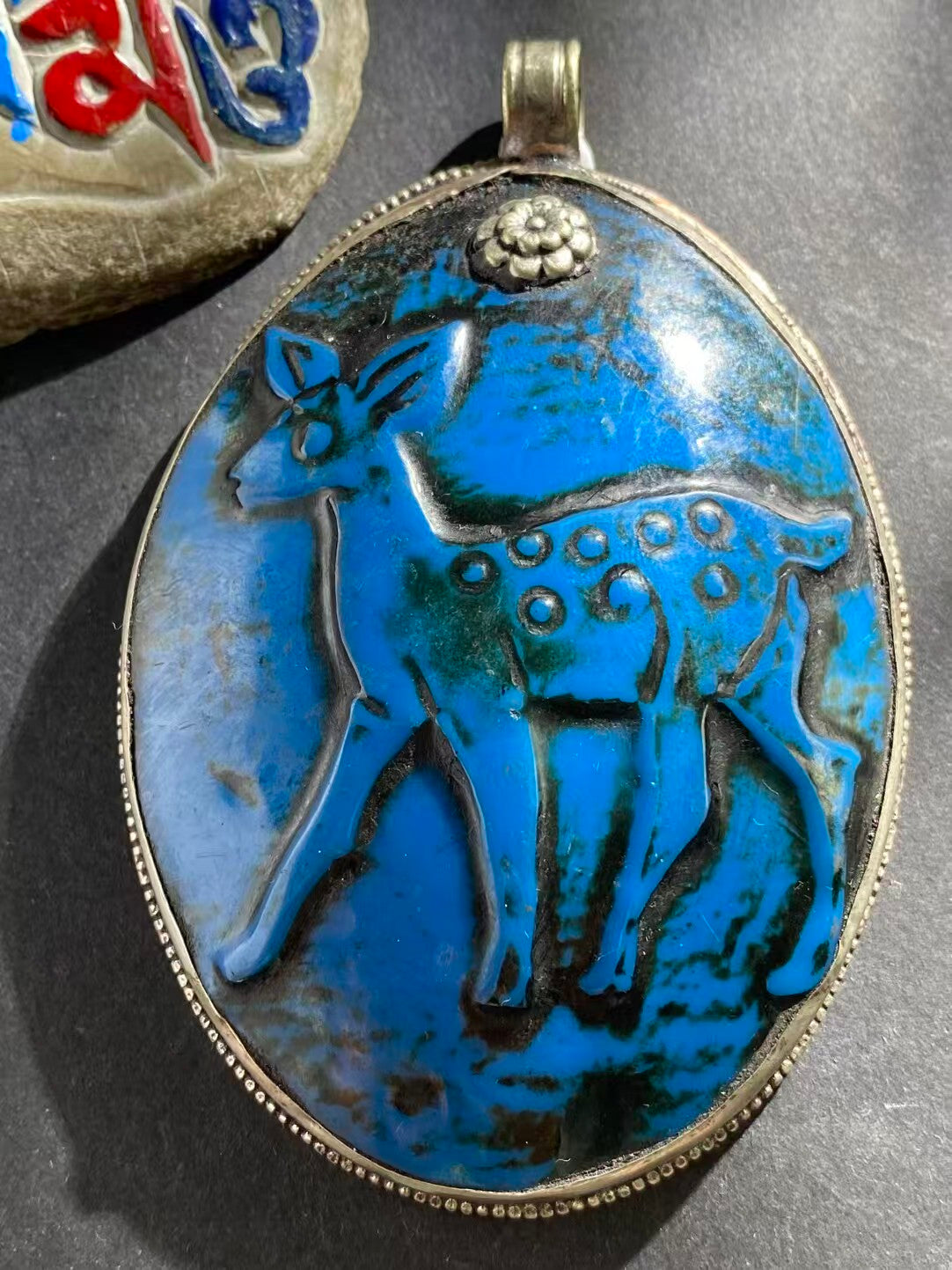 Handcrafted shell carved pendant with Tibetan Buddhist cultural influences. This unique piece symbolizes spiritual growth and harmony, combining artistry and tradition.