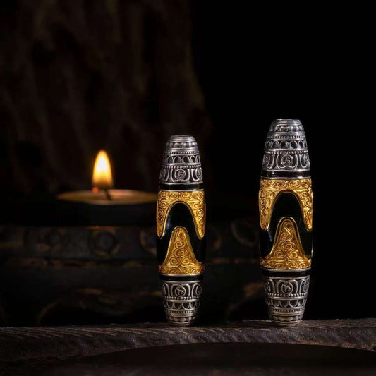 Hand-painted tiger fang dzi silver pendant inspired by Tibetan Buddhist jewelry culture, symbolizing courage and protection.