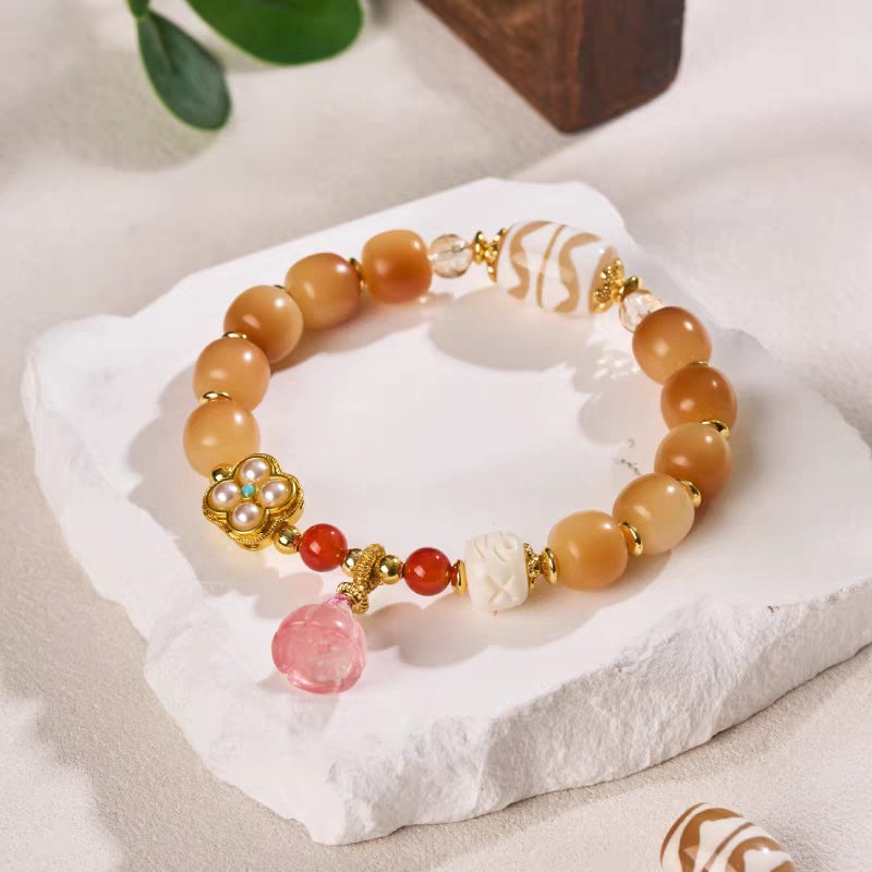 Authentic Double Tiger Tooth Dzi bead bracelet, handcrafted in Tibetan Buddhist tradition, symbolizing wealth, protection, and spiritual energy.