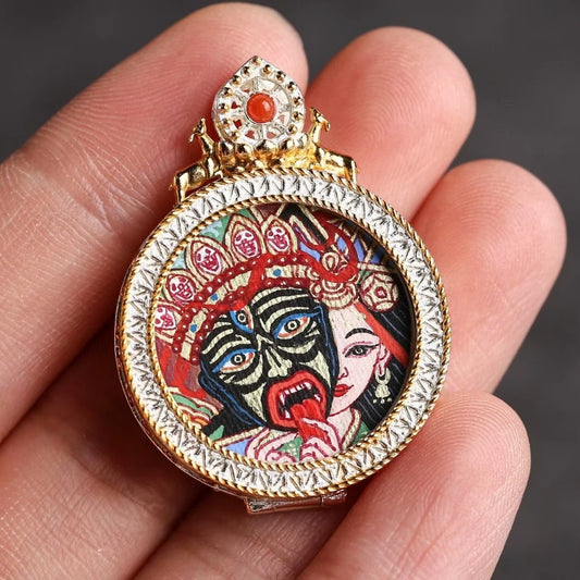 Hand-painted silver Zaki Lam Tangka pendant inspired by Tibetan Buddhist jewelry culture, symbolizing fortune and protection.
