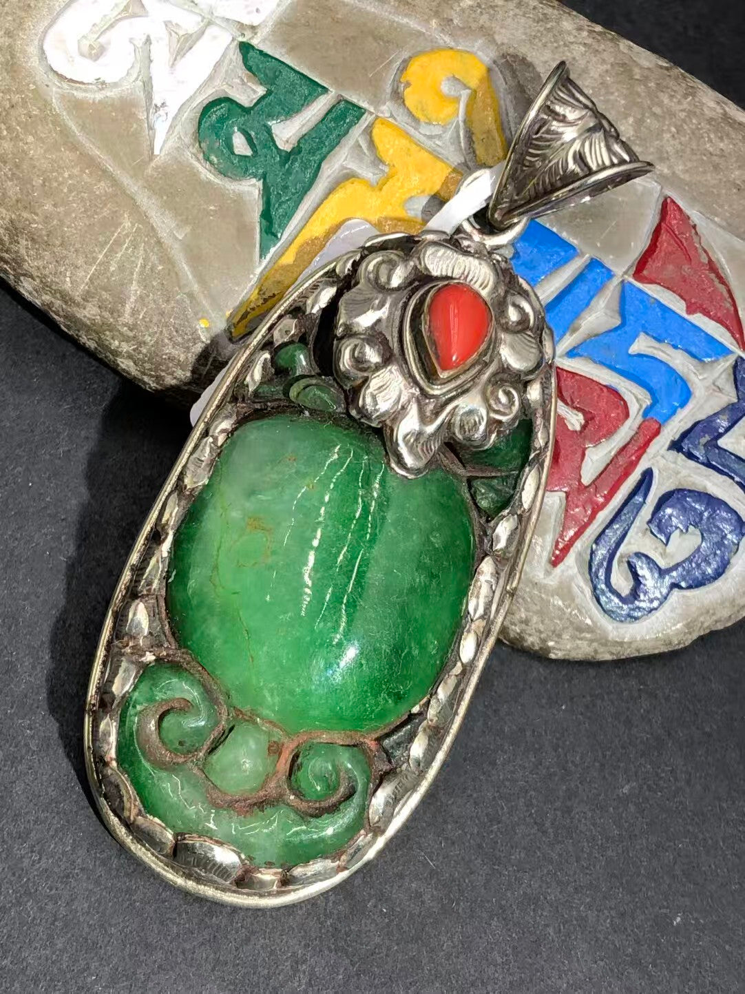Old jade pendant with a hand-painted design, embodying Tibetan Buddhist art. A meaningful accessory symbolizing wisdom, balance, and spiritual enlightenment.