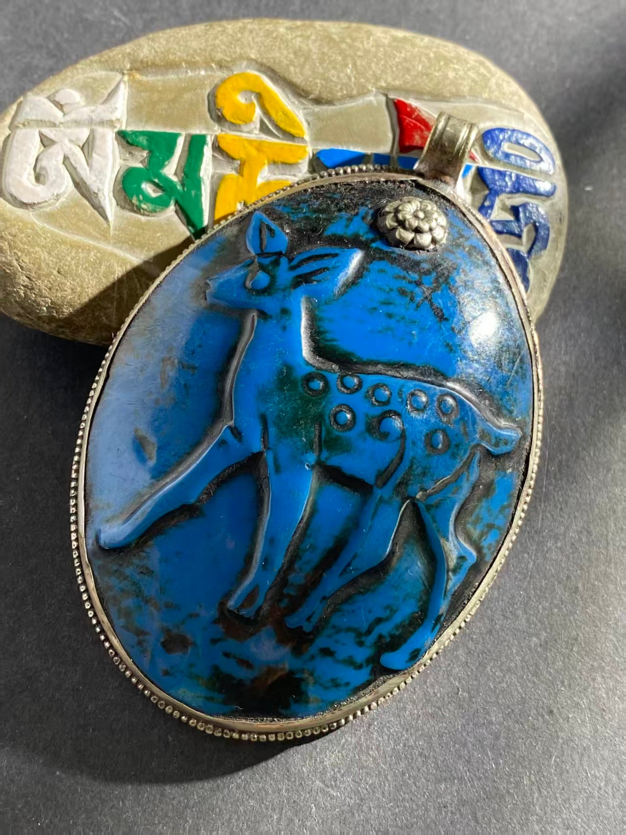 Handcrafted shell pendant with intricate carved design, infused with Tibetan Buddhist symbolism. A spiritual and artistic piece for those seeking meaning and beauty.