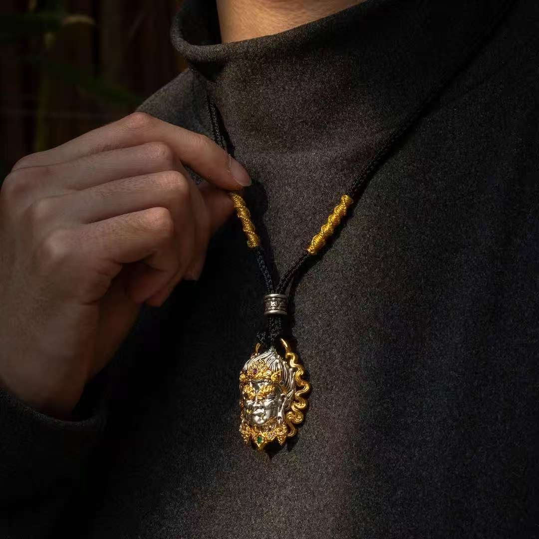 Sacred silver Fudo Myoo amulet pendant representing Tibetan Buddhist jewelry culture and powerful guardian energy.