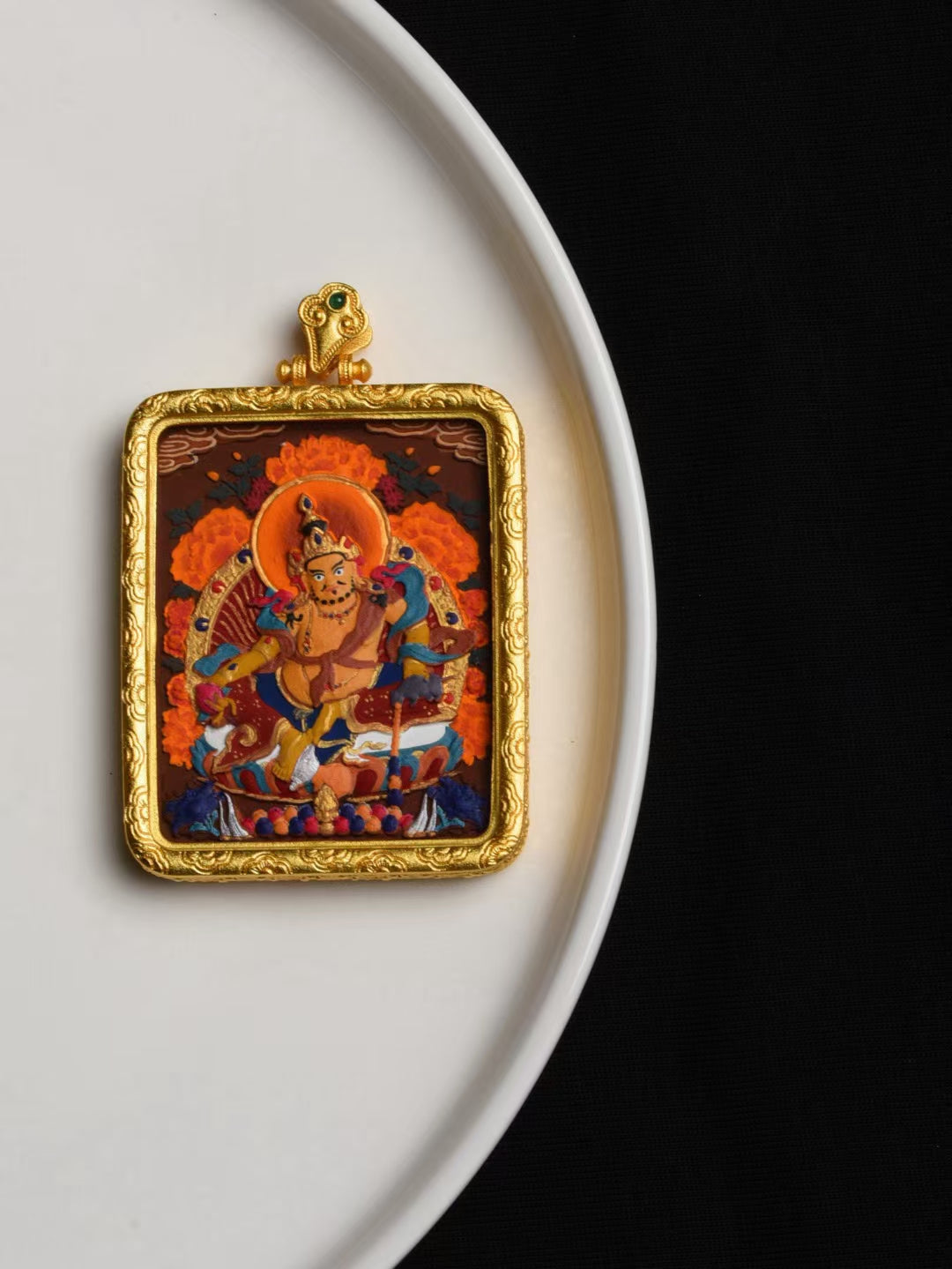 Sacred Yellow Jambhala thangka pendant representing Tibetan Buddhist jewelry culture, a spiritual jewelry art piece for prosperity.