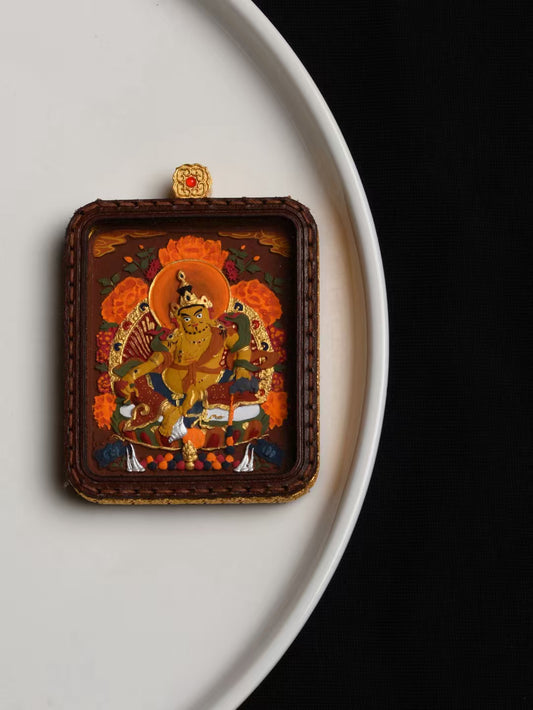Sacred Yellow Jambhala Thangka pendant representing Tibetan Buddhist jewelry culture, a spiritual talisman for attracting wealth and good fortune.
