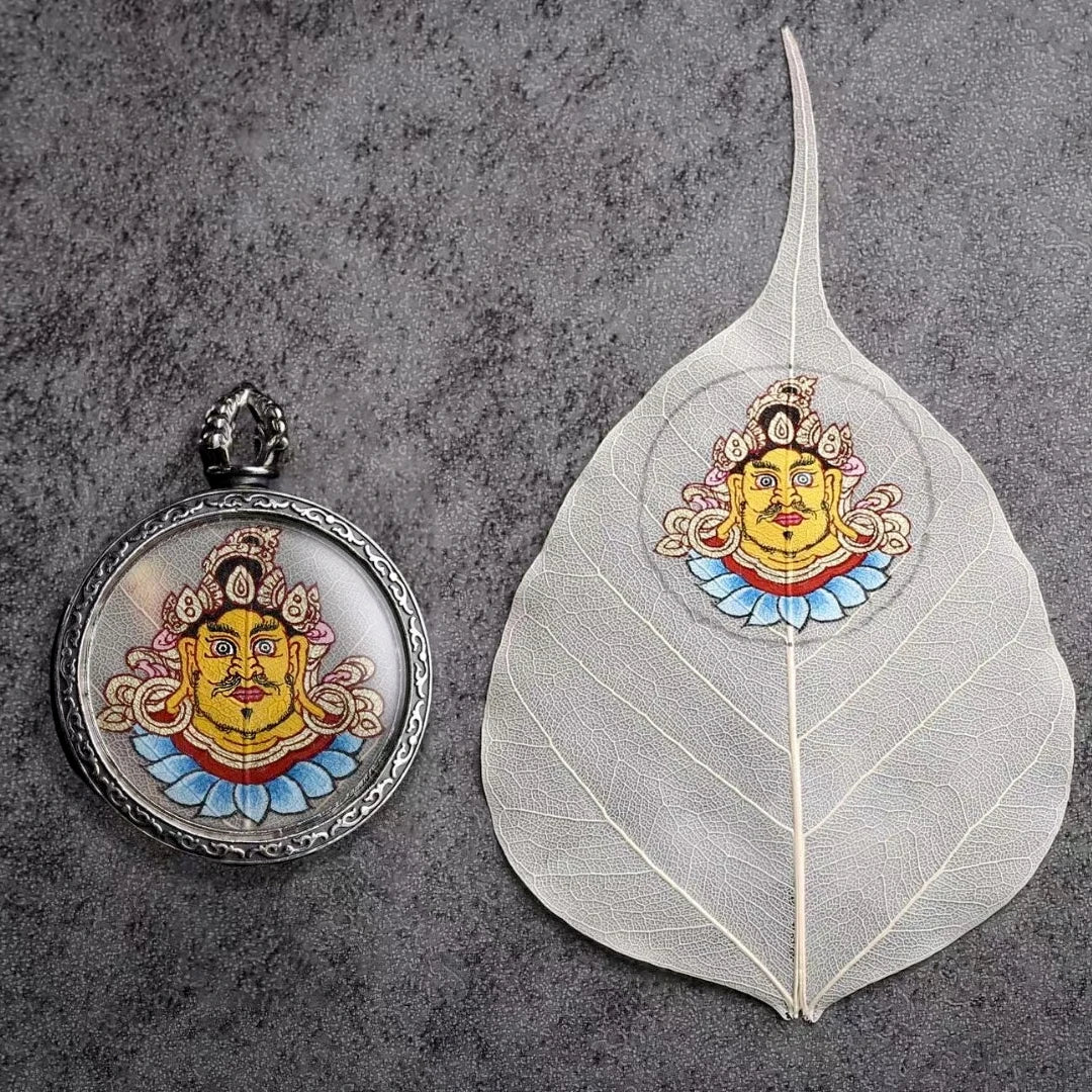 Hand-painted Zaki Lam Yellow Wealth Buddha Thangka pendant necklace with Blue Bodhi Leaf, designed to bring prosperity, protection, and spiritual growth