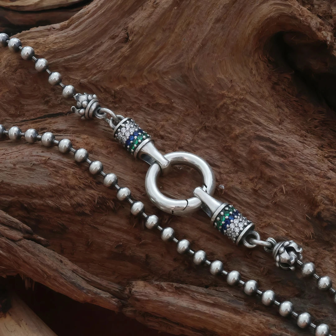 Hand-painted silver thangka pendant inspired by Tibetan Buddhist jewelry culture and sacred jewelry art.