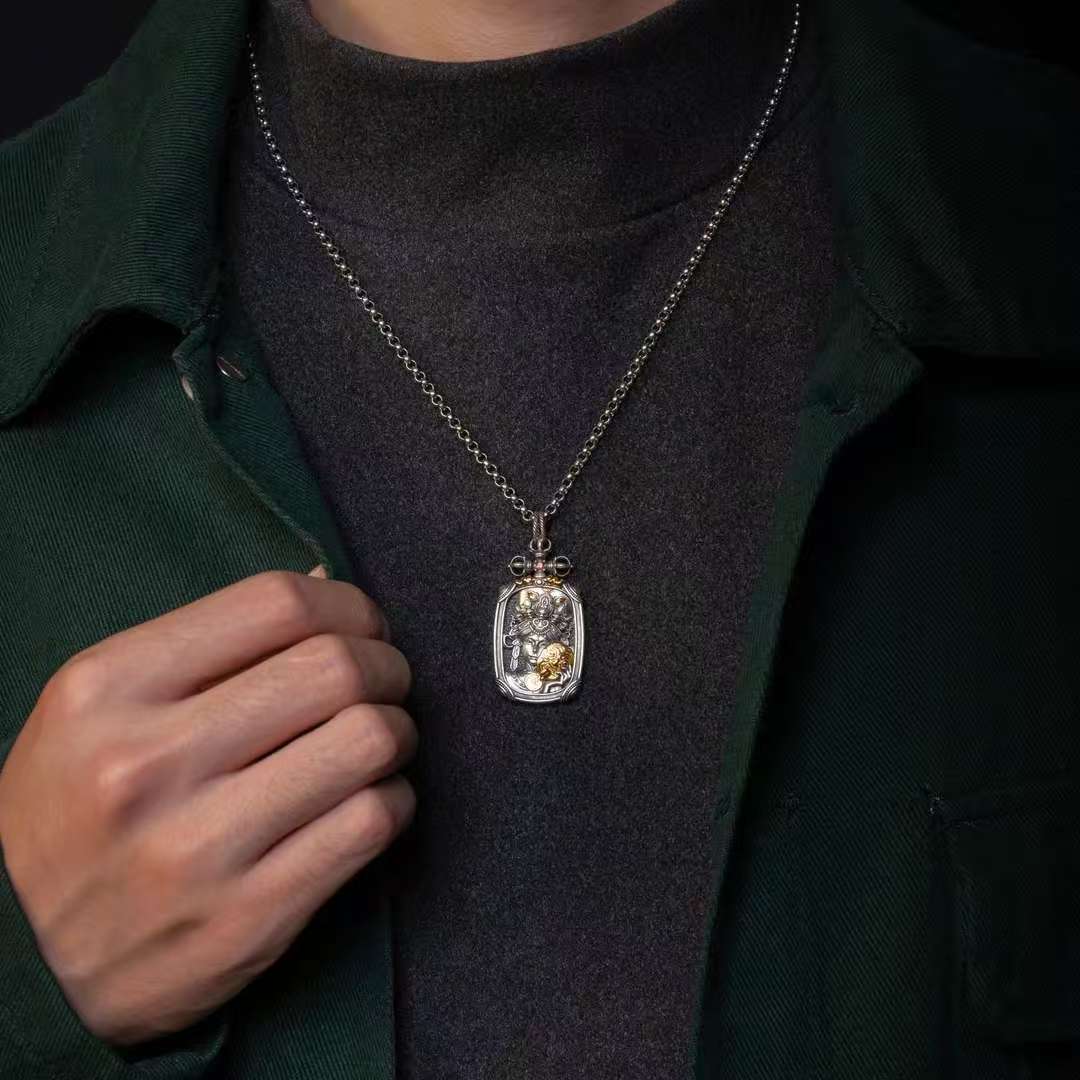 Handcrafted silver Buddhist pendant with Ten Auspicious Symbols, reflecting Tibetan Buddhist jewelry culture and devotion.