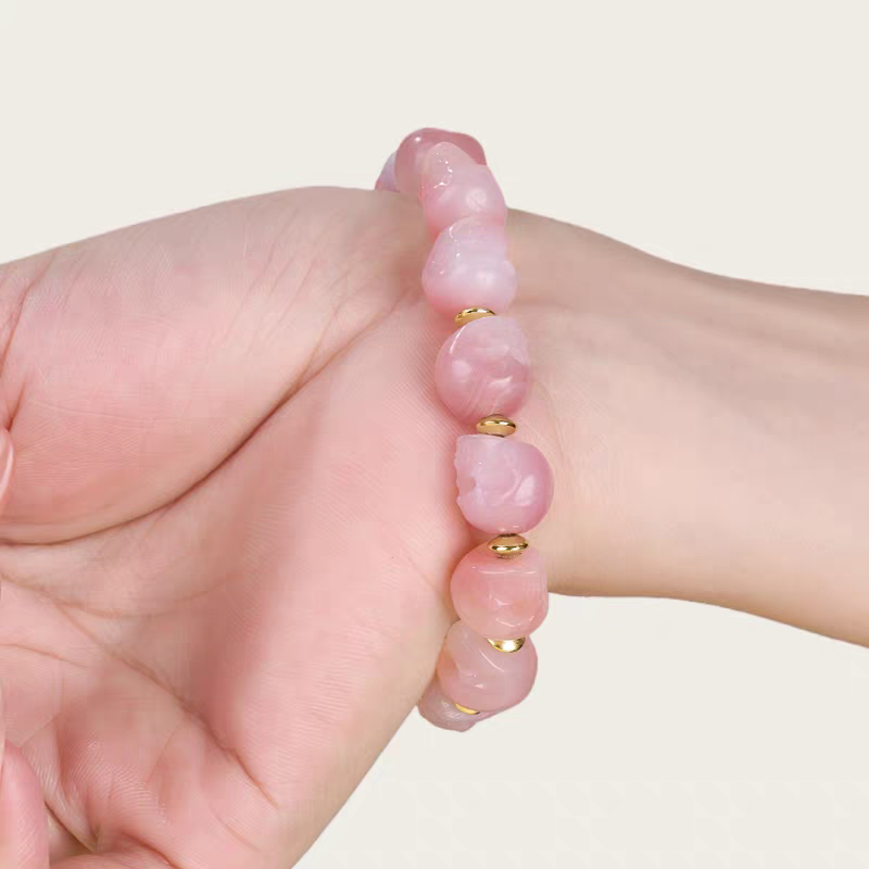Female pink Lychee Dzi Beads Beaded Bracelet, handcrafted Tibetan Buddhist jewelry, spiritual accessory for peace and wellbeing.”