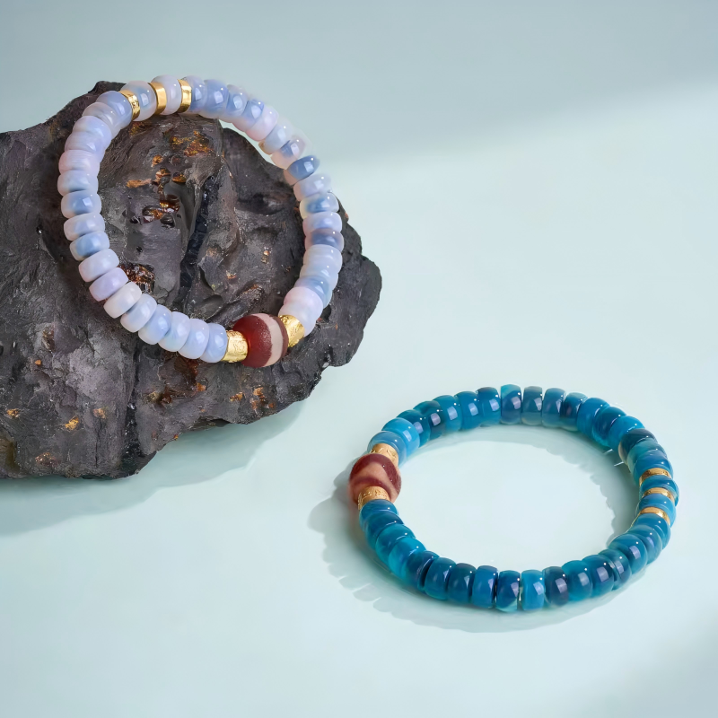 Ethnic style Dzi bead bracelet with red coral and blue bubble beads, handcrafted for spiritual balance, protection, and traditional Tibetan jewelry art.
