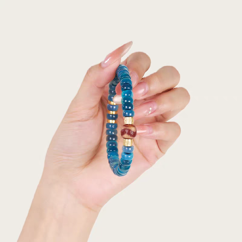 Spiritual Tibetan red coral tiger tooth Dzi bead bracelet, handcrafted, ideal for meditation, attracting positive energy, and showcasing jewelry art.