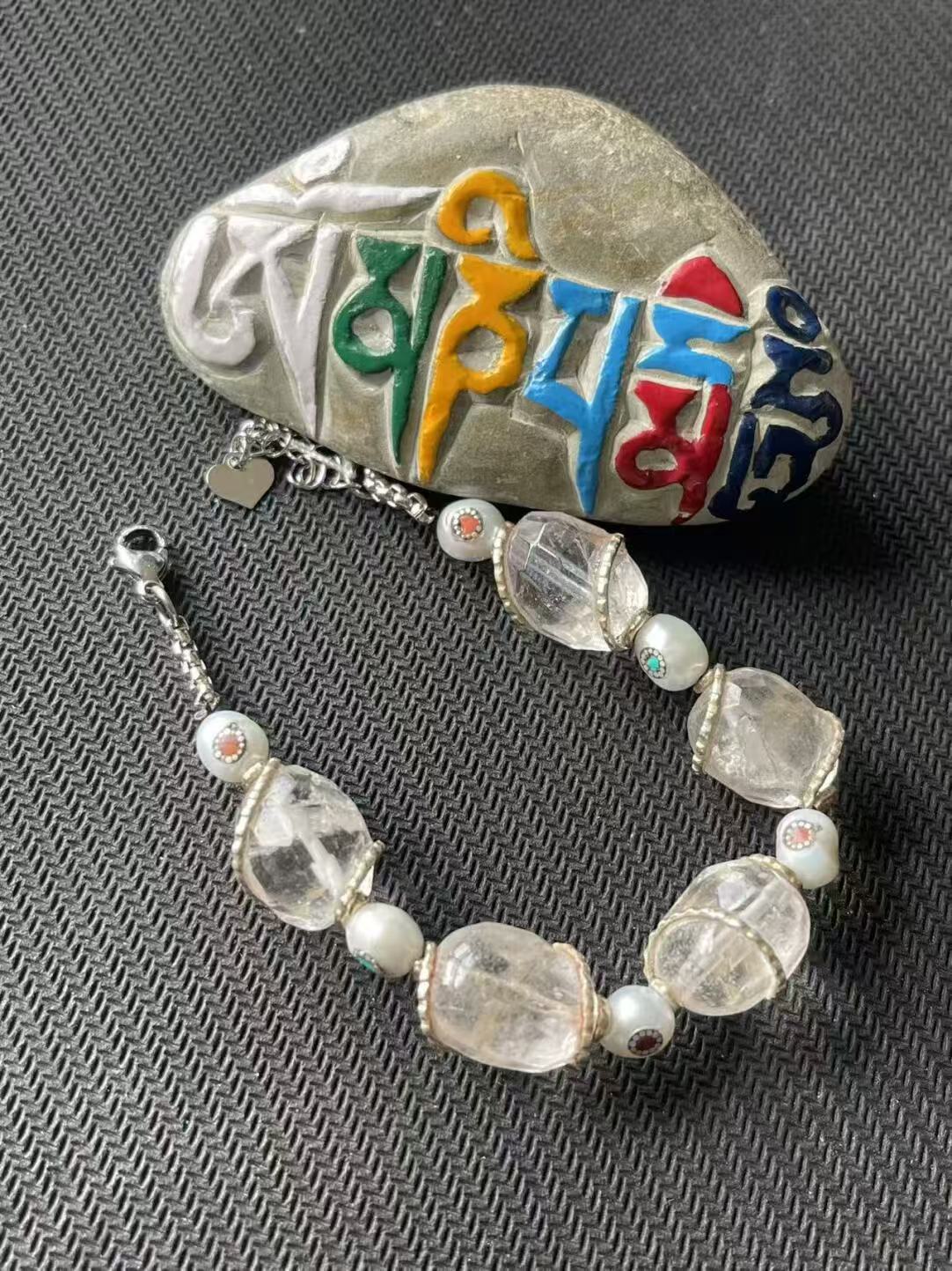 Celebrate Tibetan Buddhist traditions with this hand-painted red floral bracelet, meticulously crafted for a refined, spiritual accessory.