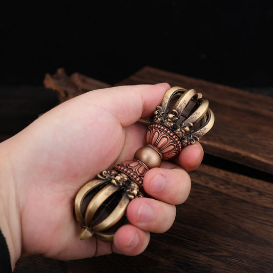 A 13cm handcrafted Nine-Pronged Vajra made from brass and copper, symbolizing the power and wisdom of Tibetan Buddhism. This exquisite ritual implement is ideal for altars and spiritual spaces.