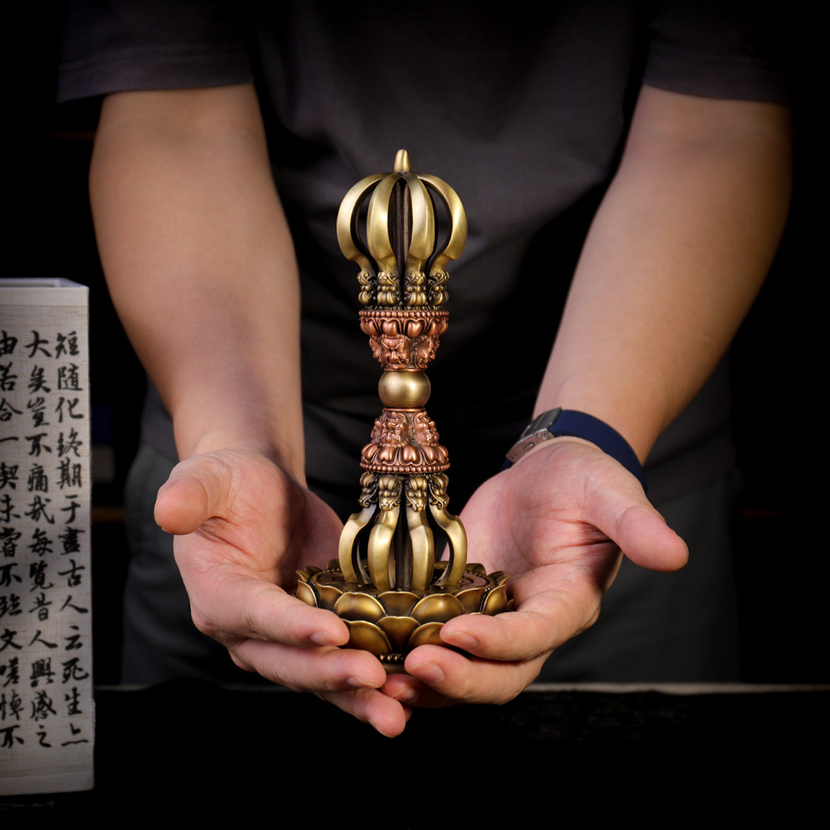 A 21cm handcrafted Nine-Pronged Vajra with a base, made from brass and copper. This ritual implement represents the unshakable wisdom and protection in Tibetan Buddhist culture.