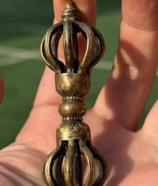 This Tibetan Buddhist Vajra ritual tool is meticulously handcrafted from brass, representing powerful spiritual strength and wisdom. It embodies Tibetan Buddhist ritual implements culture and makes a perfect piece for collection or meditation.
