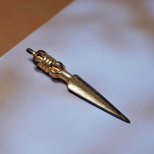 This antique Tibetan brass Phurba features intricate gold gilding, handcrafted with care. A sacred ritual tool symbolizing spiritual power and protection, perfect for meditation or as a collectible piece.