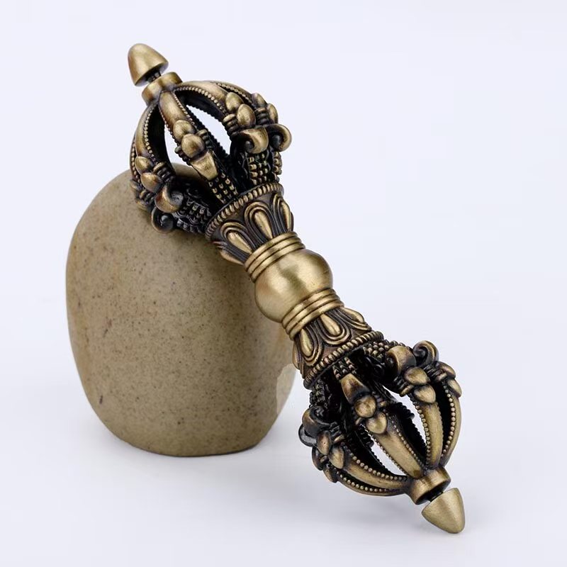 "Handcrafted Brass Five-Prong Vajra, a symbol of wisdom and protection in Tibetan Buddhism. Crafted using traditional methods, perfect for spiritual rituals and home decor