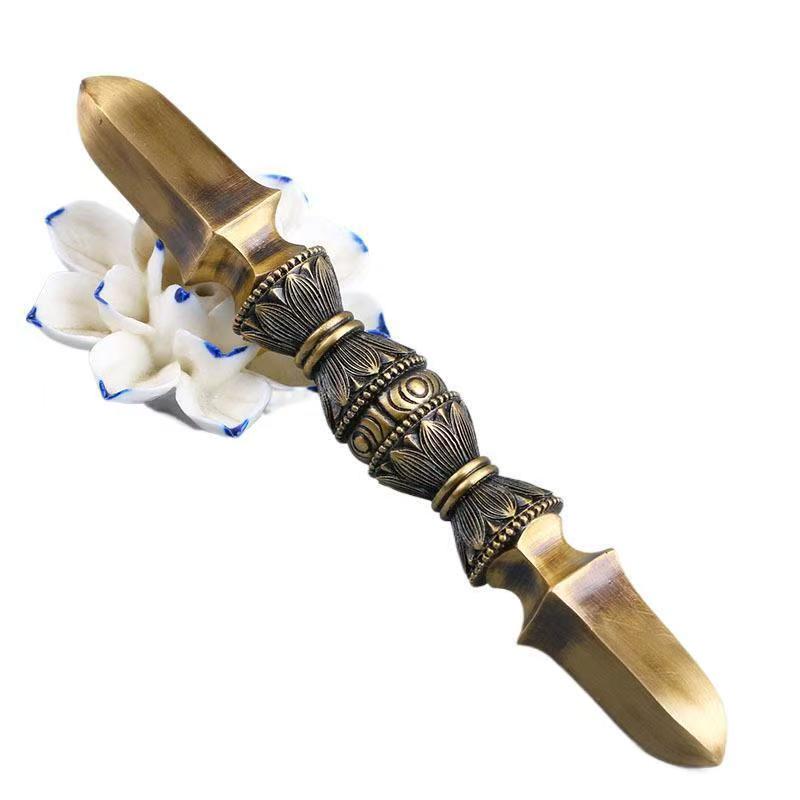 Handcrafted brass single-prong Vajra, an exquisite piece of Tibetan Buddhist ritual art. Perfect for enhancing spiritual spaces and meditation rooms with its symbolic power.