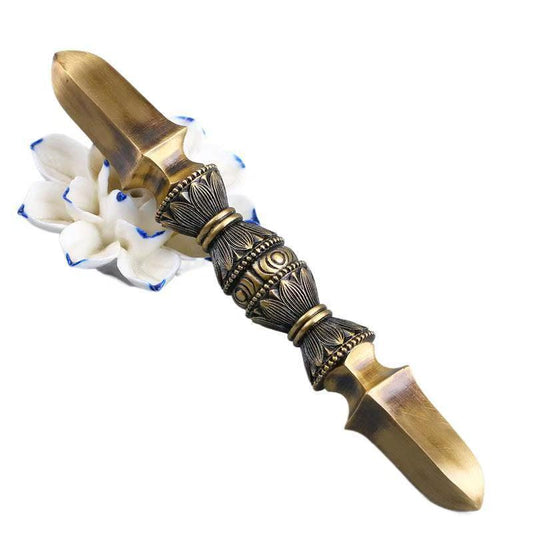 Handcrafted brass single-prong Vajra, an exquisite piece of Tibetan Buddhist ritual art. Perfect for enhancing spiritual spaces and meditation rooms with its symbolic power.