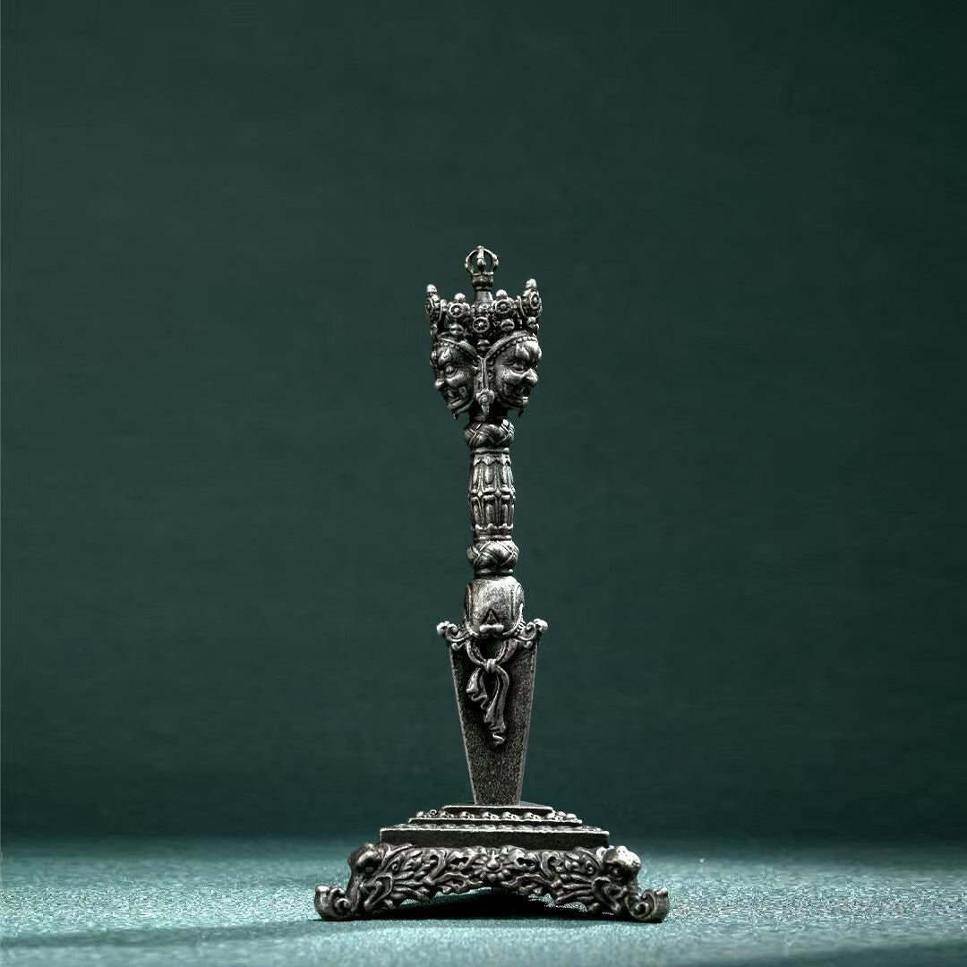 Brass Three-Pronged Phurba with Gessho Flower, handcrafted for Tibetan rituals. Ideal for meditation, spiritual purification, and energy protection.