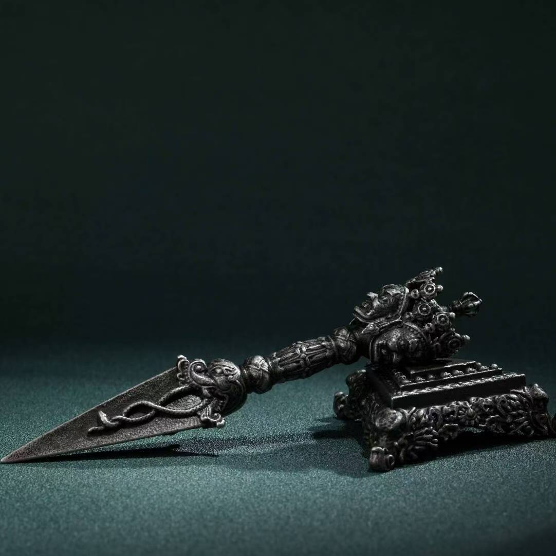 Brass Three-Pronged Phurba with Base, featuring a Gessho Flower design. Handcrafted for rituals and spiritual practice, providing purification and protection.