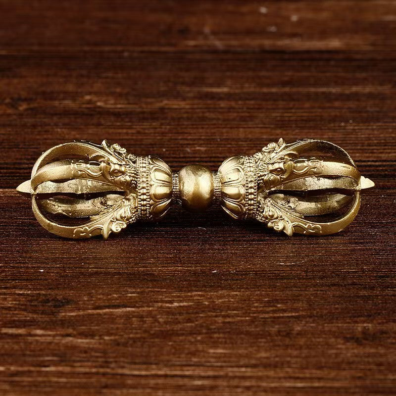 Handcrafted brass Vajra representing Tibetan Buddhist ritual implements culture, a sacred Buddhist ritual art used for meditation and spiritual protection.