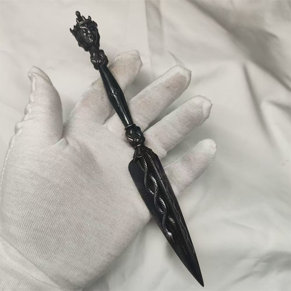 Handmade brass three-sided Phurba, crafted in Tibetan Buddhist ritual implements culture, used for purification, removing obstacles, and invoking spiritual protection in rituals.