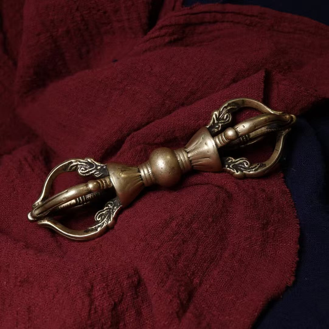 This Qing Dynasty-inspired Tibetan Vajra features five prongs, handcrafted in brass. A powerful ritual tool symbolizing protection and spiritual wisdom, perfect for meditation or home decor.
