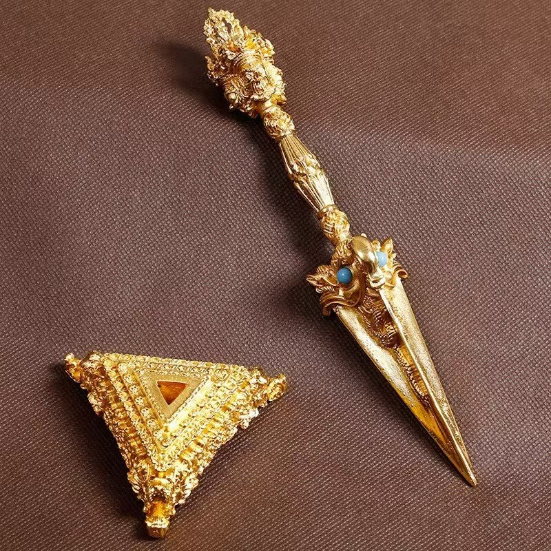 Handcrafted gilded brass three-faced Phurba with base, symbolizing spiritual protection and wisdom. This ritual art piece blends Tibetan Buddhist tradition with fine craftsmanship, perfect for any collection or sacred space.