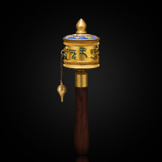 A beautifully handcrafted Green Tara hand rattle in brass and enamel, representing the goddess Tara's protection and wisdom. Perfect for meditation spaces.