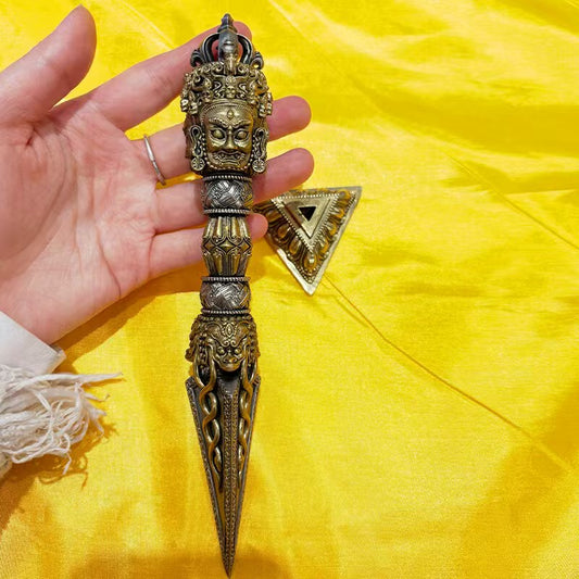 Handcrafted brass Phurba Vajra from Tibetan Buddhist ritual implements culture, used as a sacred ritual decor symbolizing protection and spiritual power.