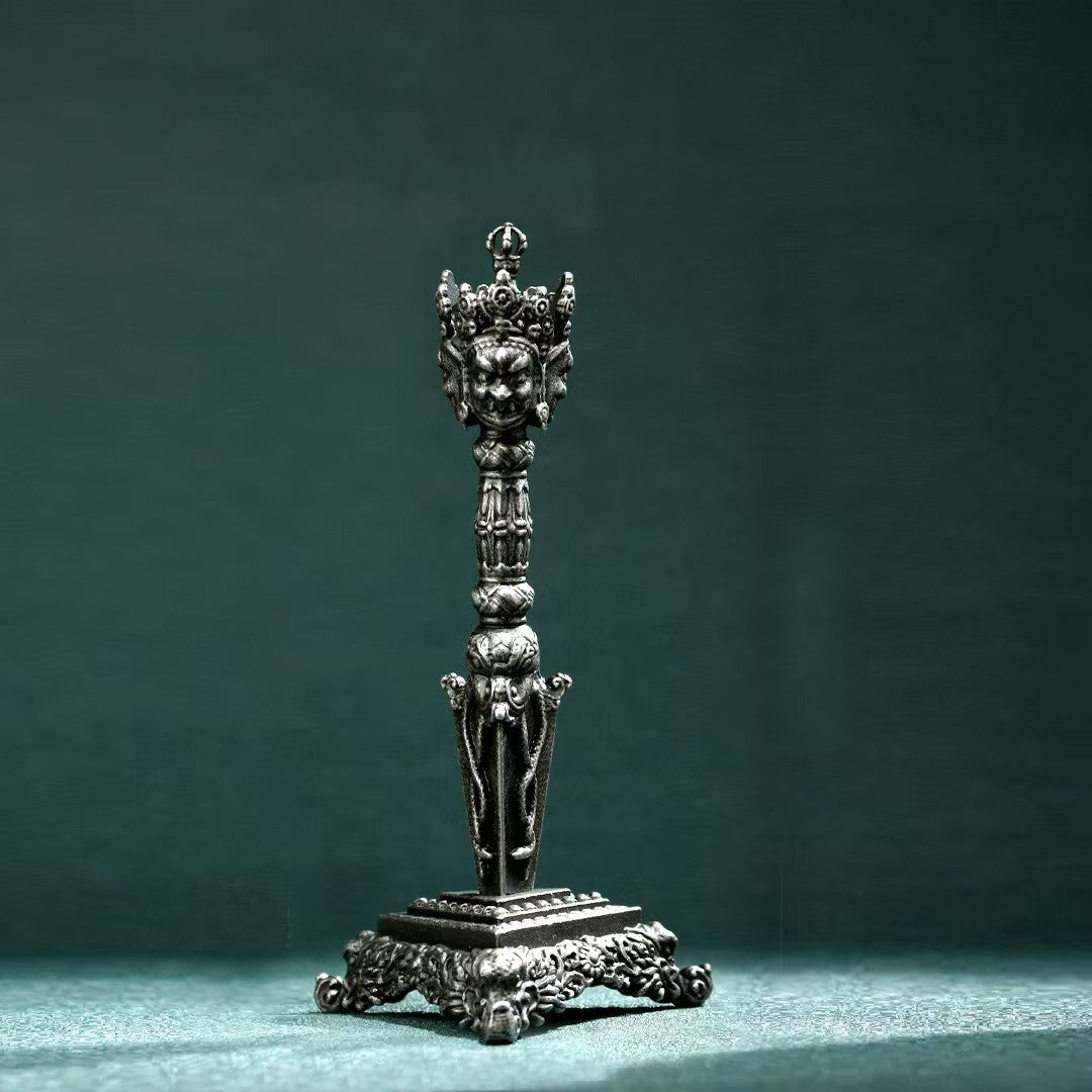 Brass Three-Pronged Phurba with Gessho Flower, ideal for meditation and Tibetan rituals. Handcrafted for purification, protection, and spiritual strength