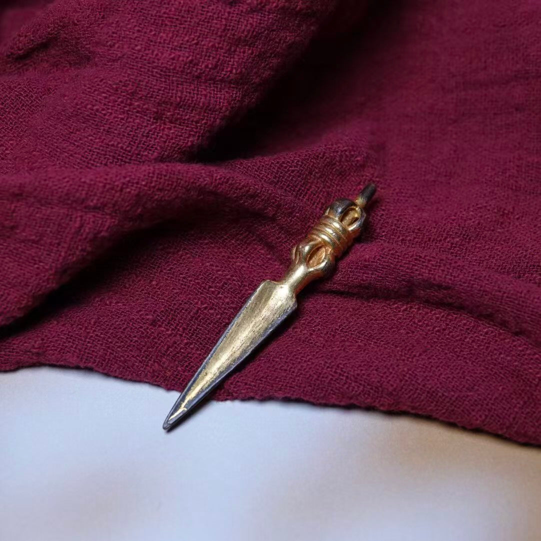 Handcrafted from brass and finished with gold plating, this Tibetan Phurba is a powerful ritual tool, symbolizing wisdom and protection. Ideal for spiritual practices or as a meaningful decorative piece.