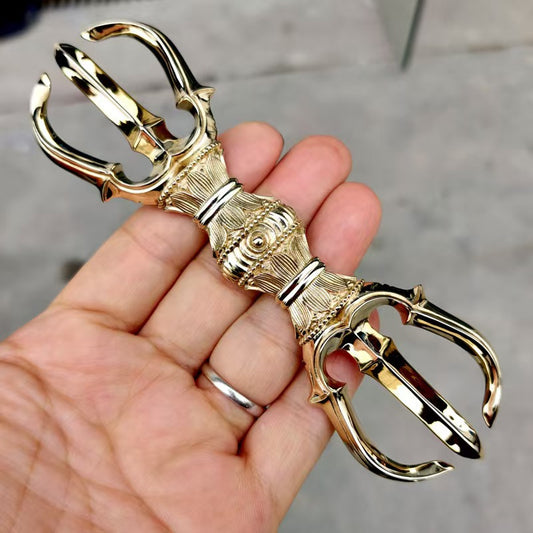 Brass Three-Pronged Vajra, handcrafted for use in Tantric rituals. A sacred Tibetan Buddhist artifact symbolizing strength, wisdom, and spiritual transformation. Perfect for Buddhist altars and meditation rooms