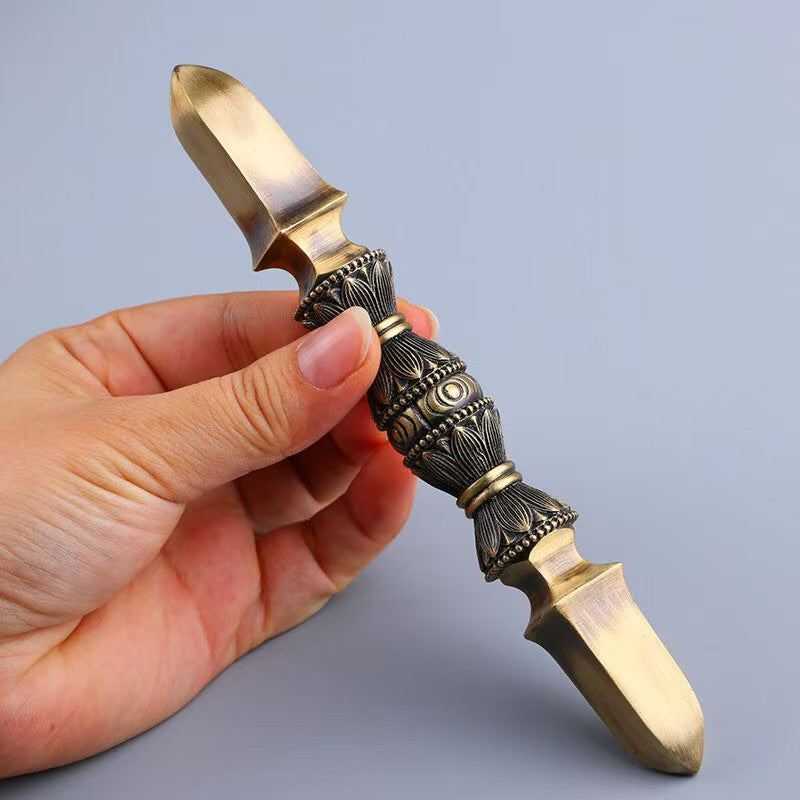 Elegant handcrafted brass single-prong Vajra, a spiritual art piece inspired by Tibetan Buddhist ritual implements. A perfect addition to any sacred space or collection
