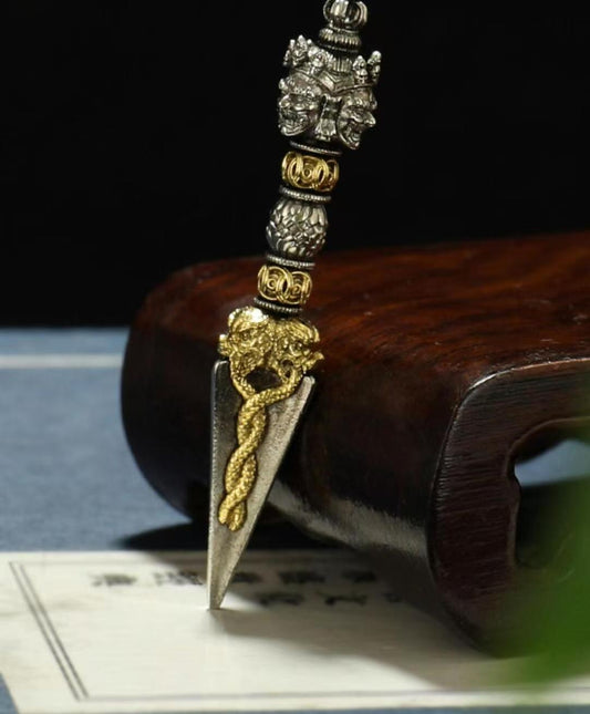 A brass Phurba Vajra handcrafted for ritual use, embodying powerful protective energy in Tibetan Buddhism. Ideal for rituals, meditation, and spiritual practices