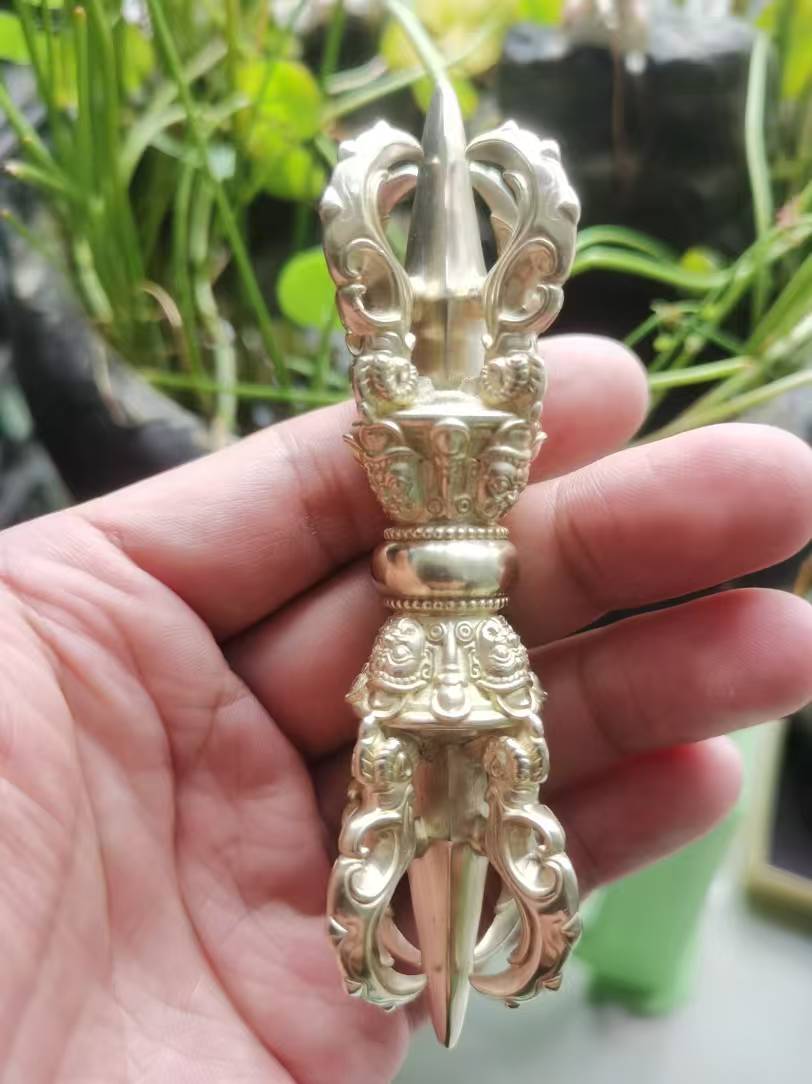A beautifully crafted brass Vajra, symbolizing spiritual strength and protection. This piece is an essential addition to any Buddhist ritual collection.