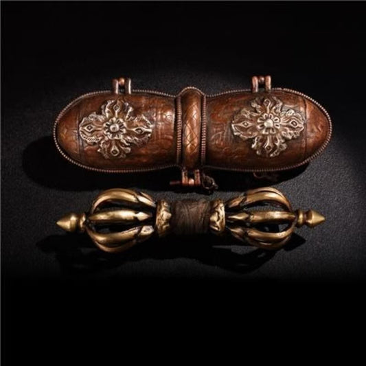 This handcrafted nine-pronged Vajra is a Tibetan Buddhist ritual tool crafted from antique brass, perfect for meditation, rituals, and spiritual practices. Its intricate design reflects the ancient tradition of Tibetan craftsmanship and is believed to provide spiritual protection and purification. Ideal for collectors and practitioners alike, this piece adds authentic Tibetan artistry to any sacred space.