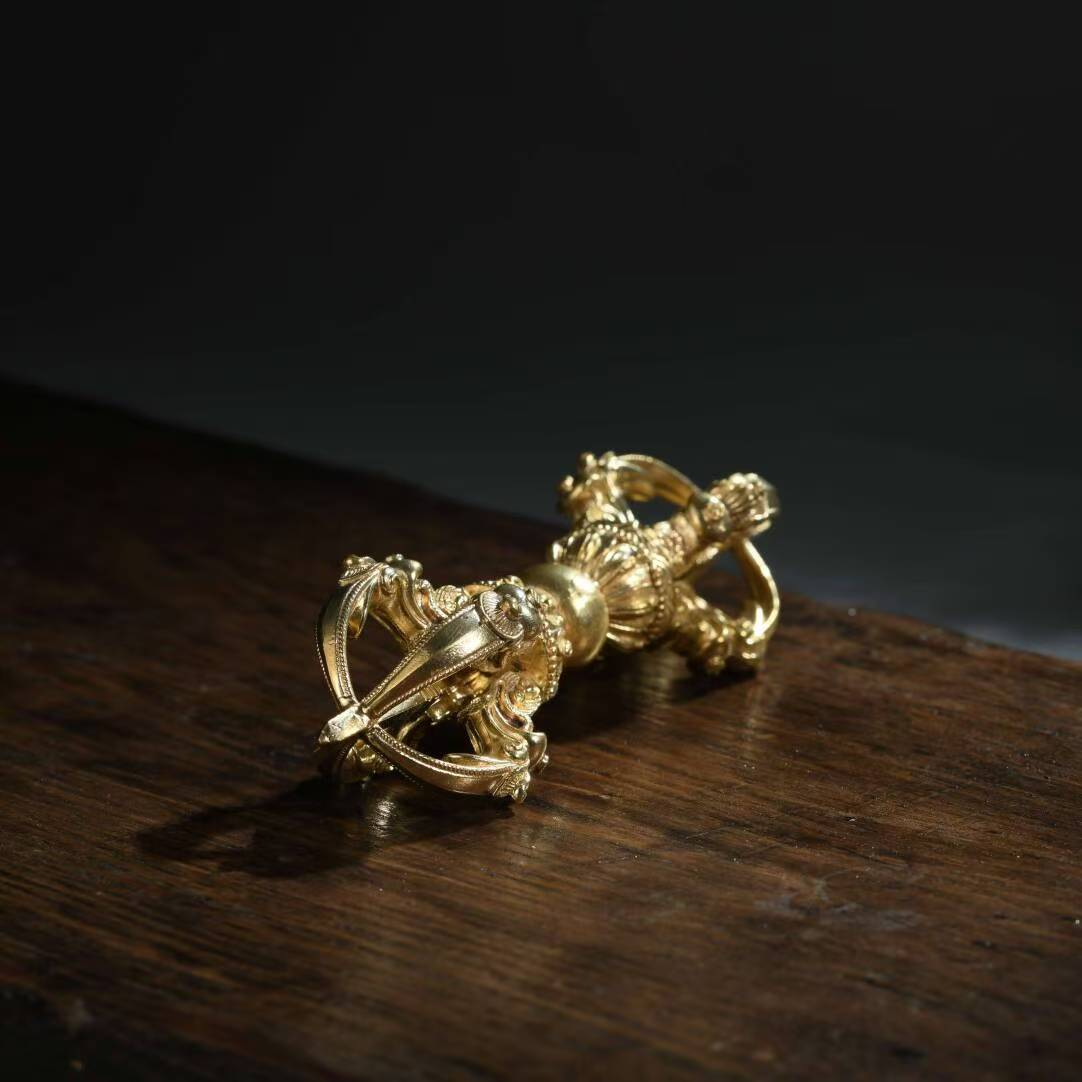 The brass five-pronged Phurba Vajra is a sacred ritual tool in Tibetan Buddhism. Handcrafted in Nepal, it is used for protection, purification, and spiritual awakening. Ideal for Tibetan altars and spiritual practices.