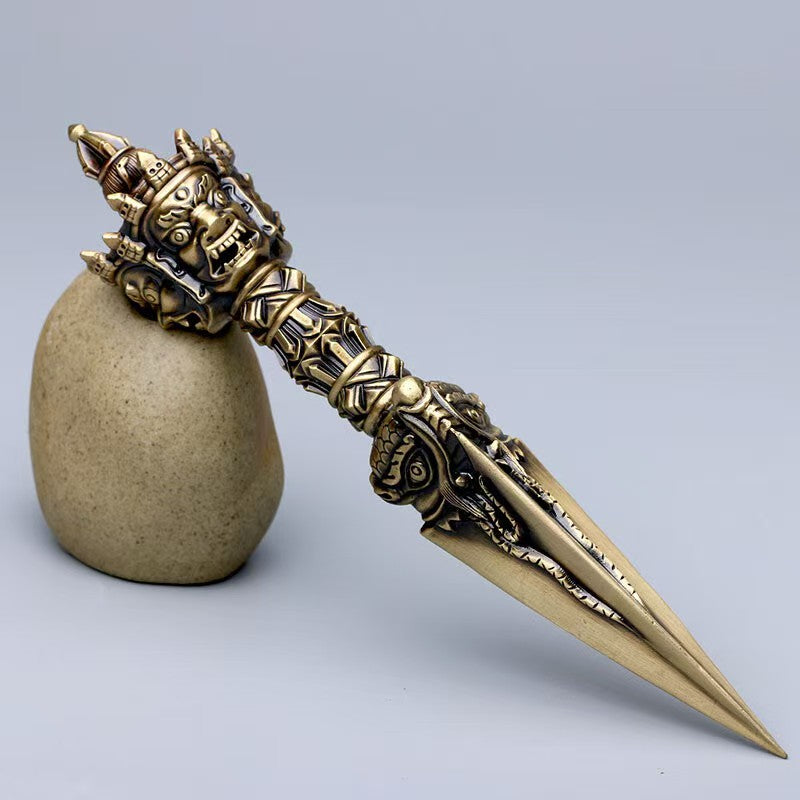 Brass Phurba Vajra handcrafted for spiritual purification in Tibetan Buddhist ritual implements culture, meaningful Buddhist ritual implements art for personal transformation.