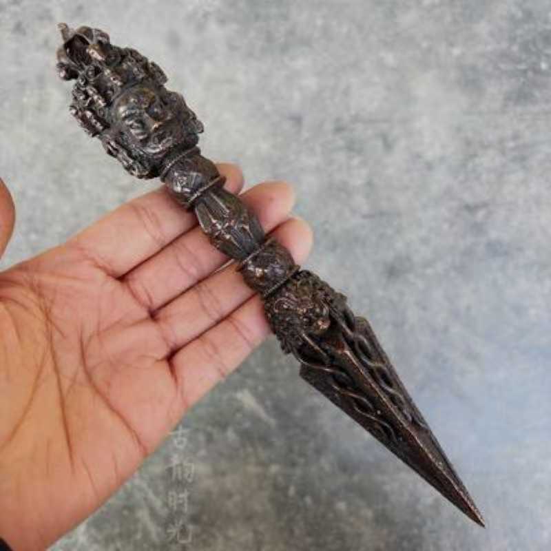 Handcrafted from brass, this Three-Faced Phurba with Vajra is a powerful ritual tool in Tibetan Buddhism, used to protect, purify, and remove negative influences. A sacred artifact for spiritual practices and meditation.