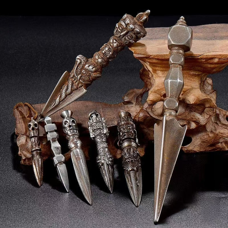 This vintage-style Brass Phurba Dagger with an iron carved flower vajra is a powerful Tibetan Buddhist ritual tool. Made by skilled artisans in Nepal, it symbolizes spiritual power, protection, and purification. Ideal for ritual use, this antique Phurba also serves as a spiritual artifact to enhance any Buddhist altar or meditation space. Its intricate design and handcrafted details reflect the beauty of Tibetan Buddhist art.