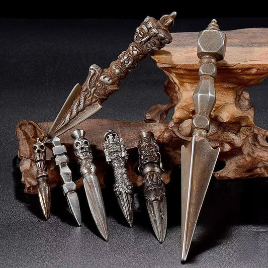 This vintage-style Brass Phurba Dagger with an iron carved flower vajra is a powerful Tibetan Buddhist ritual tool. Made by skilled artisans in Nepal, it symbolizes spiritual power, protection, and purification. Ideal for ritual use, this antique Phurba also serves as a spiritual artifact to enhance any Buddhist altar or meditation space. Its intricate design and handcrafted details reflect the beauty of Tibetan Buddhist art.