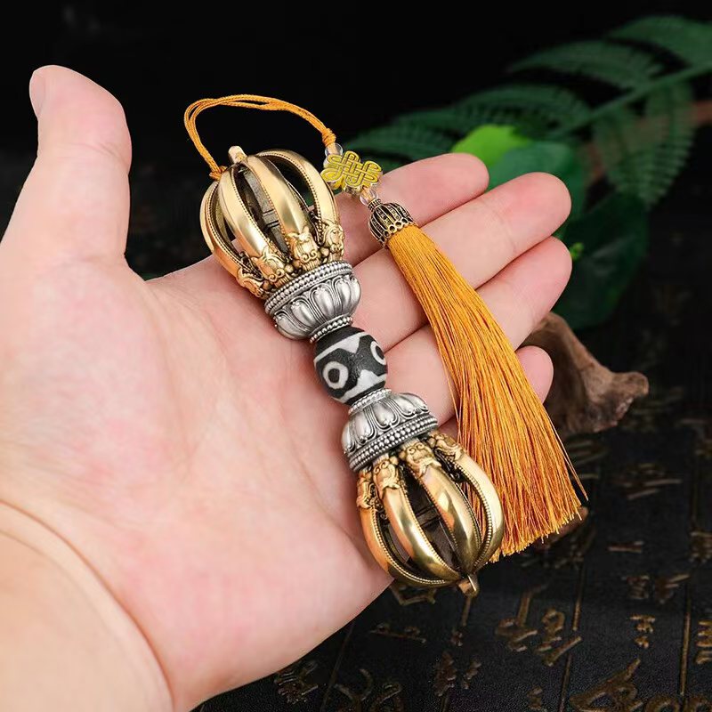 This handcrafted brass Phurba, featuring nine prongs, represents divine protection and wisdom. A unique Tibetan Buddhist ritual implement that doubles as a stunning art piece for any space.