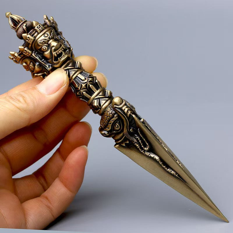 Phurba Vajra for protection and purification crafted in Tibetan Buddhist ritual implements culture, handcrafted brass tool in Buddhist ritual implements art for spiritual clarity.